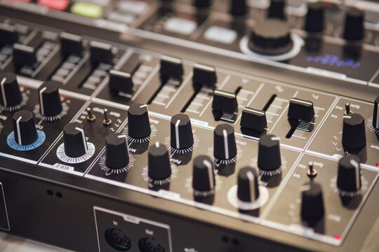Audio mixing console close-up. Audio equipment in a recording studio.