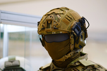 Helmet with headphones for an army radio on a mannequin. Portable military communications