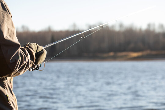 fisherman fishing on the river bank, Fishing rod, spinning