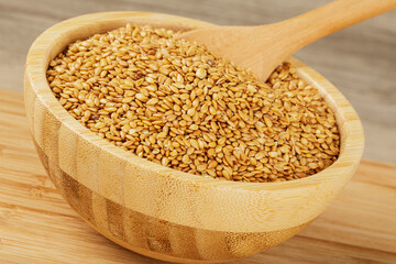 Wooden bowl filled with healthy and delicious Roasted Flax Seeds