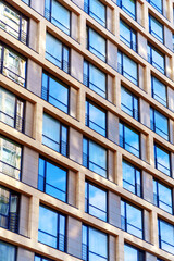 Fototapeta premium The facade of the building with large windows and false balconies