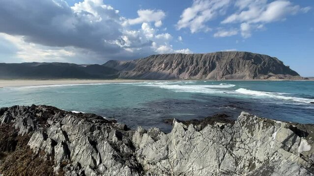 Beautiful Sunny Summer Day at the Rocky Shores of the Barents Sea near the City of Berlev&aring;g, waves rolling in