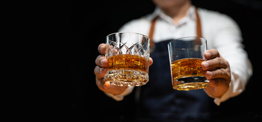 Barman pouring whiskey whiskey glass..
