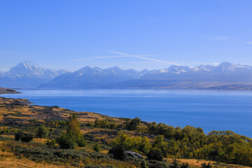 Scenic view of Mount Cook, New Zealand. On the way to Mount Cook nation park at Peter's lookout we can see panoramic view with lake Pukaki and mountain range. Beautiful blue sky with turquoise water.