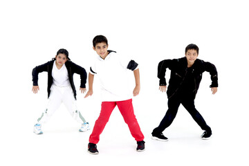 Happy student kid group studying modern style dance in indoor studio classroom, children, boys and girl, dancing on white background. Three little dancers practicing break dance together.