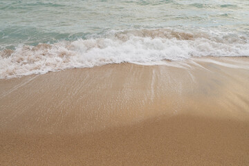 Sandy beach with small waves background