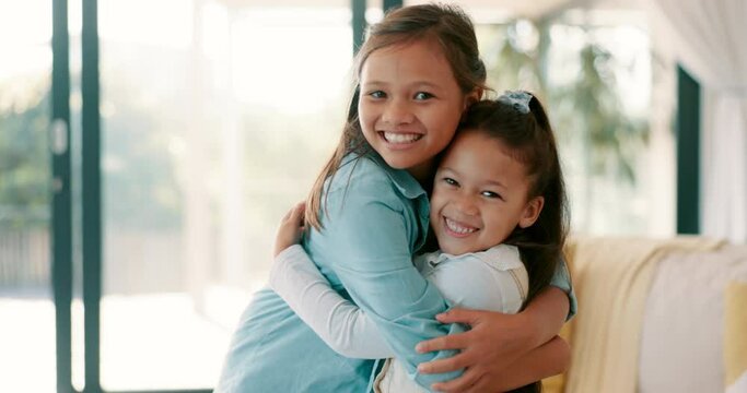 Happy little girl, hug and siblings for love, care or bonding together in living room at home. Portrait of sisters embracing childhood, unity or teamwork in happiness for youth and affection in house