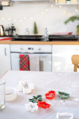 Layout of cookie cutters close-up cut out cookies from the dough with molds on a Christmas theme in the form of a snowman, a Christmas tree, stars in the kitchen