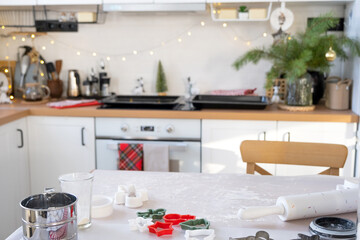 Layout of cookie cutters close-up cut out cookies from the dough with molds on a Christmas theme in the form of a snowman, a Christmas tree, stars in the kitchen