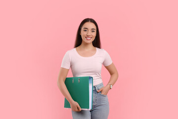 Happy woman with folder on pink background