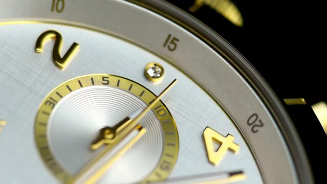luxury gold chronograph wrist watches close up. Hand watch with the seconds hand ticking.