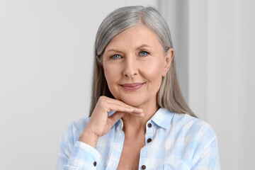Portrait of beautiful senior woman with gray hair indoors