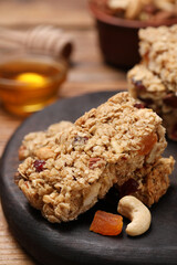 Tasty granola bars on table, closeup view