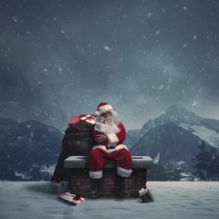 Foto op Aluminium Tired pensive Santa Claus sitting on a chimney © stokkete