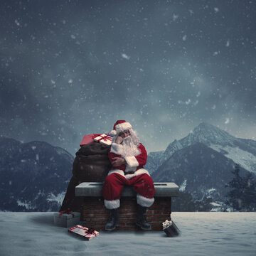 Tired pensive Santa Claus sitting on a chimney