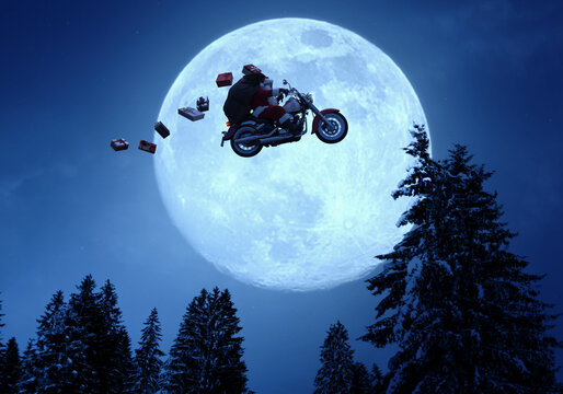 Santa Claus riding a motorcycle and flying in the sky