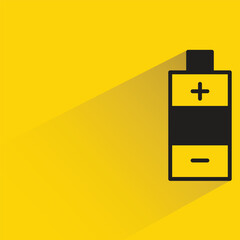 battery with shadow on yellow background