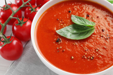Delicious tomato cream soup in bowl on table, closeup
