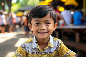 An indonesian boy kid smile at camera