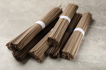 Uncooked buckwheat noodles (soba) on light grey table