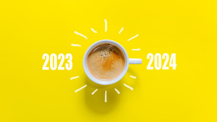 Happy new year and Merry Christmas 2024. Cup of coffee change and download 2023 to 2024 on yellow background. Start up and New Year Concept. Copy space - obrazy, fototapety, plakaty