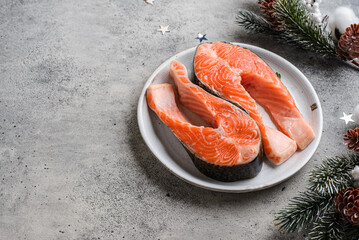raw salmon steaks on the skin in a Christmas