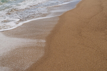 Sandy beach with small waves background