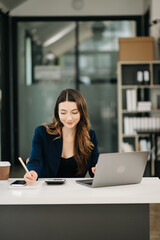 Confident Asian woman with a smile standing holding notepad and tablet