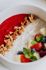 Sweet milk semolina porridge with strawberries on beautiful plate. Delicious breakfast for children