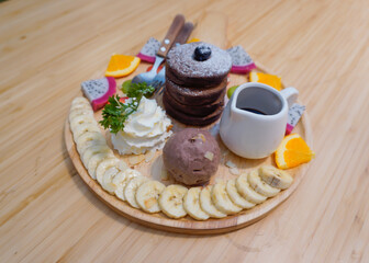 Chocolate pancake tower comes with ice cream and fruit in a delicious plate. Sweet, refreshing, smooth and delicious, deliciously decorated.