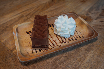 Chocolate cake with whipped cream, chocolate drizzle, ready to eat, sweet, delicious, soft on the tongue.                             