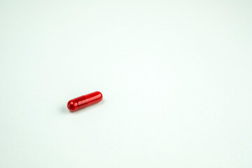 detail of a calming pill on white background