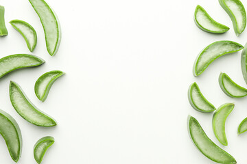 Fresh aloe vera slices on white background, flat lay. Space for text