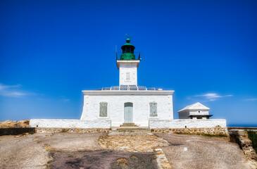 Fototapeta na wymiar The Famous Lighthouse Phare de la Pietra on the Rocky Island Ile de de la Pietra just outside L'Ile Rousse on Corsica, France