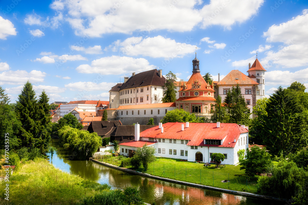 Wall mural the nezarka river floating through jindrichuv hradec in the czech republic, with the famous castle