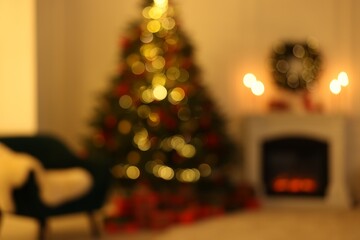 Blurred view of living room with Christmas tree near fireplace