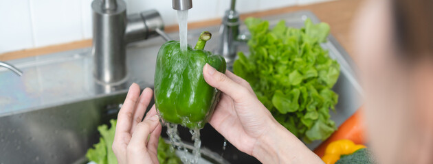 people washing raw vegetables at sink in the kitchen prepare ingredient for cooking