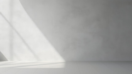 Minimal abstract light gray background for product presentation. Shadow and light from windows on plaster wall.