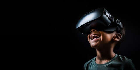 Young boy getting experience using VR headset glasses isolated on a black background with copy space - obrazy, fototapety, plakaty