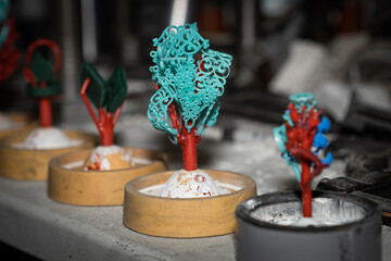 Wax treeing run number on table for casting jewelry process unfinished.