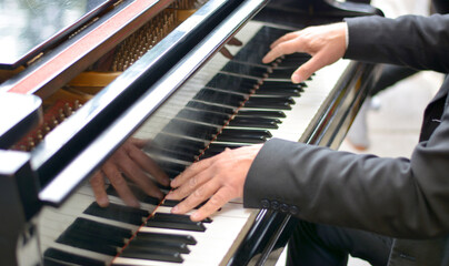 the pianist with his skillful hands touches a melody on the grand piano - obrazy, fototapety, plakaty