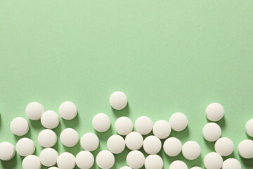 white pills on green background