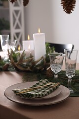 Christmas place setting with festive decor on table, closeup
