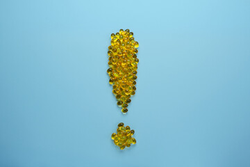 Exclamation mark made of oil filled capsules suitable for: fish oil, omega 3, omega 6, omega 9,...