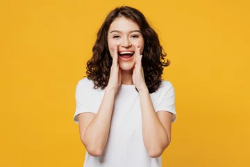 Fotobehang Young promoter fun woman she wear white blank t-shirt casual clothes scream sharing hot news about sales discount with hands near mouth isolated on plain yellow orange background. Lifestyle concept. © ViDi Studio