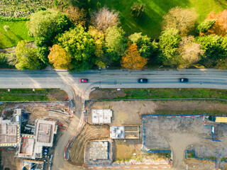 Drone top down view of a the entrance to a controversial housing development in the UK. A busy road...