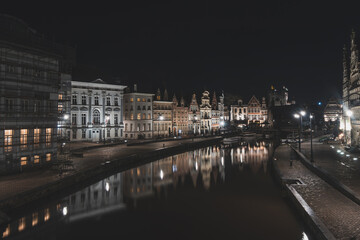 Medieval buildings on Graslei Street in the centre of Ghent by the River Leie during the night. Belgium's most famous historical centre. Ghent waterfront during midnight