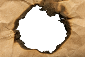 Burnt hole in yellow paper. Burnt paper