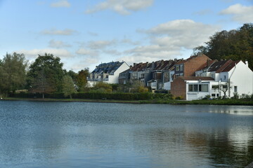 Fototapeta na wymiar Zone résidentiel se reflétant dans les eaux du Grand Etang à la Hulpe en Brabant Wallon 