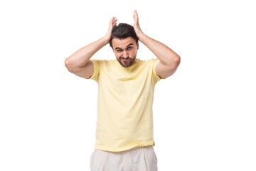 portrait of a pensive stylish brunette european man with a beard and mustache dressed in a summer t-shirt